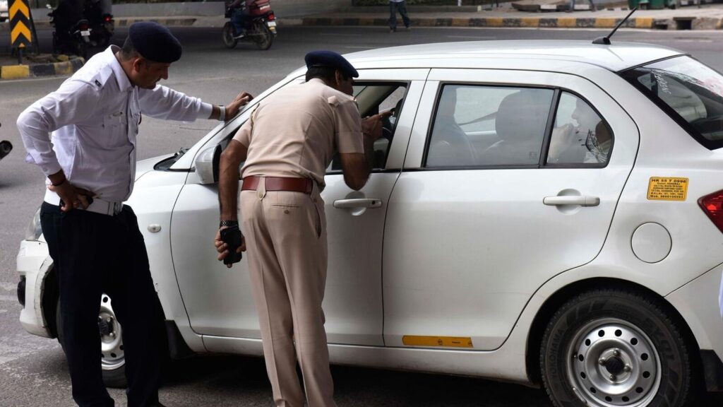 Indian Traffic Police checking vehicle documents during a roadside inspection for e-Challan and traffic rule enforcement.